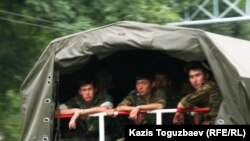 Kazakhstan - Prisoners riot. Soldiers in military truck. Almaty, 30Jul2010.