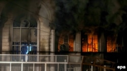 Smoke pours out of the windows of the burning Saudi Arabian Embassy during anti-Riyadh protests in Tehran on January 2.