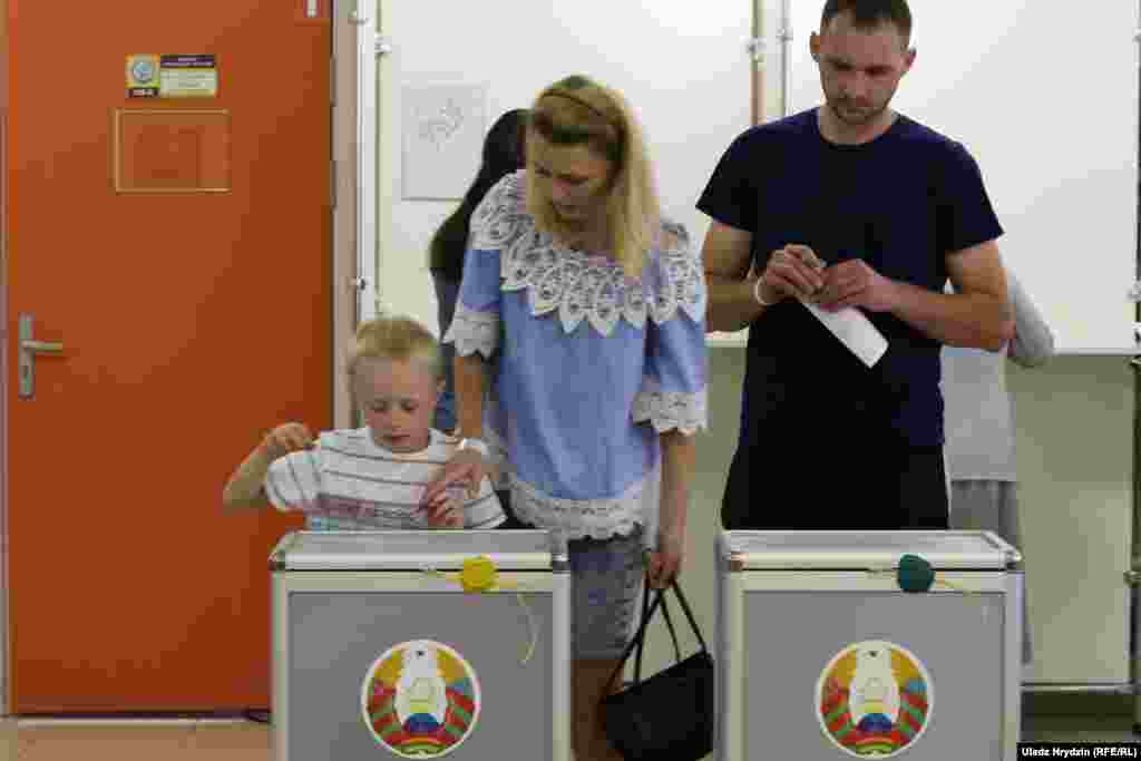 A family casts their ballots at the polling station at School No. 41 in Minsk.