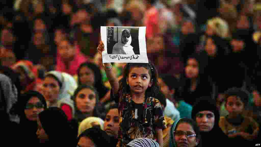 A Pakistani girl holds a photograph of Malala Yousafzai, a young activist who was shot by the Taliban, aloft during a rally in Karachi. (AFP/Rizwan Tabassum)