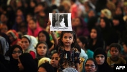 A girl holds a photograph of Malala Yousafzai aloft during a rally in Karachi on October 10.