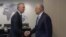 NATO Secretary-General Jens Stoltenberg (left) shakes hands with Zalmay Khalilzand at NATO headquarters in Brussels on October 21.