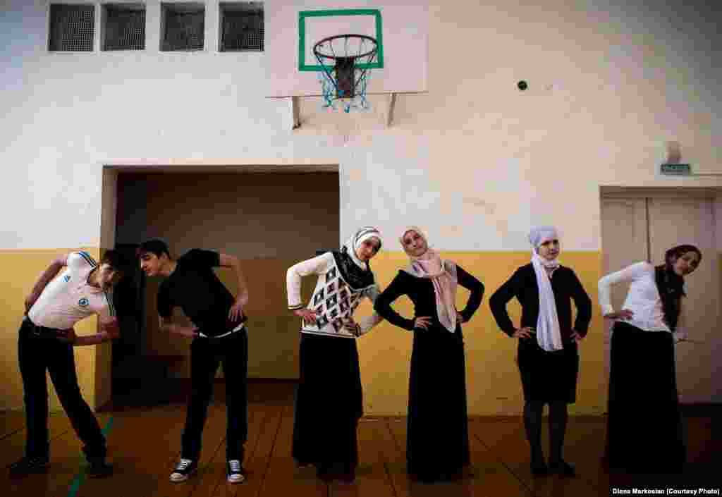 Gym class at School No. 1 in Serzhen-Yurt. The schoolgirls, all dressed in skirts and head scarves, say gym clothes violate Muslim dress codes.