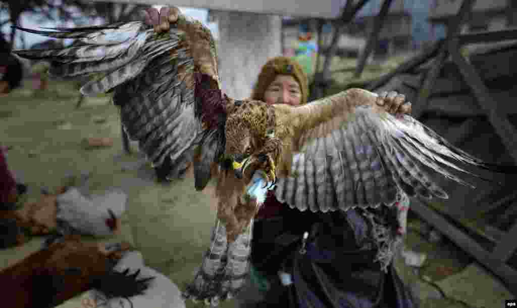 A Naga boy sells an eagle on the eve of the New Year in Kohima, Nagaland state, India, on December 31. (epa/Rajat Gupta)