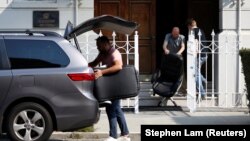 Members of Russia's consulate in San Francisco load furniture into a van after being ordered to vacate the premises in early September.