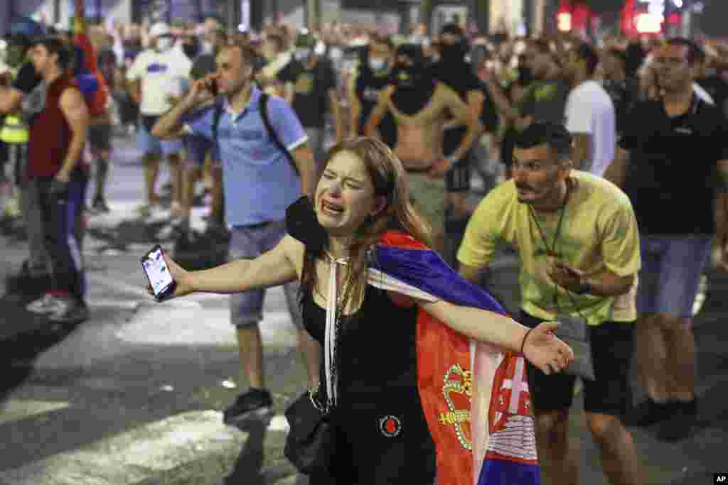A woman draped in the Serbian flag during the protests.