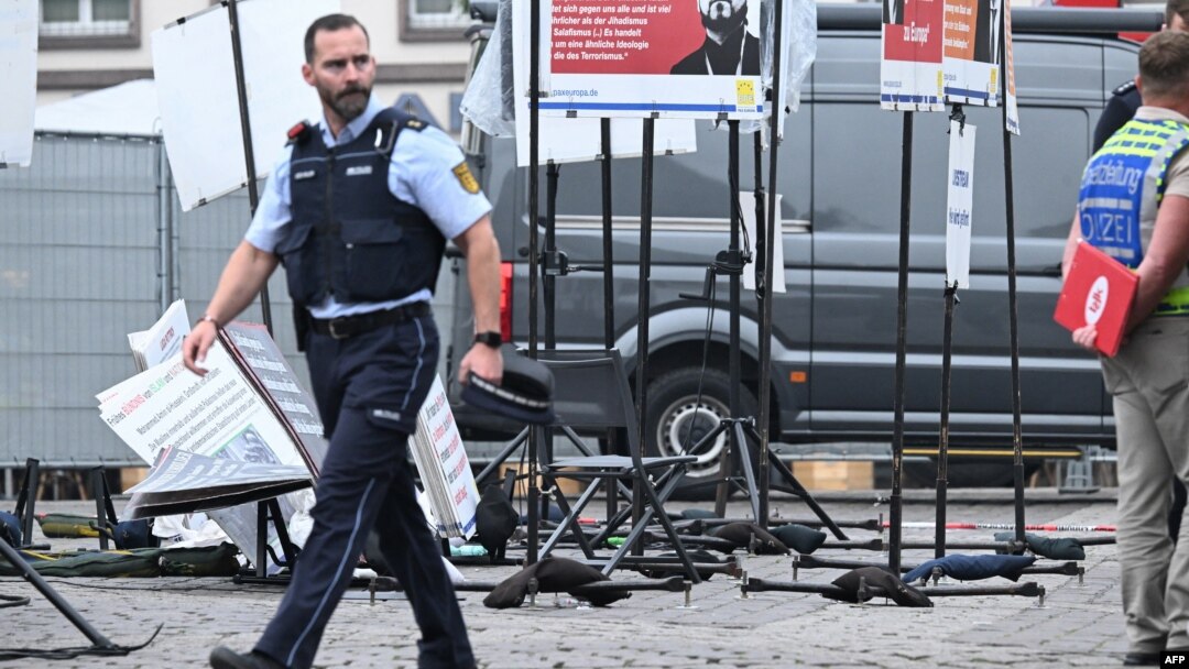 Police officers work at the scene where several people were injured in a knife attack on May 31 in Mannheim, Germany.