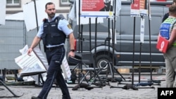 Police officers work at the scene where several people were injured in a knife attack on May 31 in Mannheim, Germany.