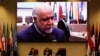 Russian Energy Minister Alexander Novak and UAE's Oil Minister Suhail Mohamed Al Mazrouei and OPEC Secretary General Mohammad Barkindo attend a meeting as Iran's Oil Minister Bijan Zanganeh is seen on a video screen in the OPEC headquarters in Vienna. December 2018