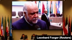 Russian Energy Minister Alexander Novak and UAE's Oil Minister Suhail Mohamed Al Mazrouei and OPEC Secretary General Mohammad Barkindo attend a meeting as Iran's Oil Minister Bijan Zanganeh is seen on a video screen in the OPEC headquarters in Vienna. December 2018