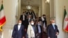 Iranian Foreign Minister Mohammad Javad Zarif (right) meets with senior Taliban leader Mullah Abdul Ghani Baradar (center) in Tehran in January. 