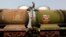 India -- A worker walks atop a tanker wagon to check the freight level at an oil terminal on the outskirts of Kolkata, November 27, 2013