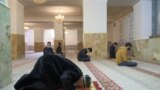 TAJIKISTAN -- Men wearing face masks pray in a mosque in Dushanbe, February 1, 2021