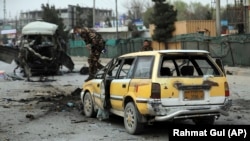 Security personnel inspect the site of a bomb attack in Kabul on March 15.