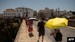 Turisti koriste kišobrane kako bi se zaštitili od sunca, Ronda, jug Španije, 9. avgusta 2024.