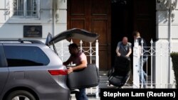 Officials of the Russian Consulate-General load furniture into a vehicle in San Francisco on September 2.