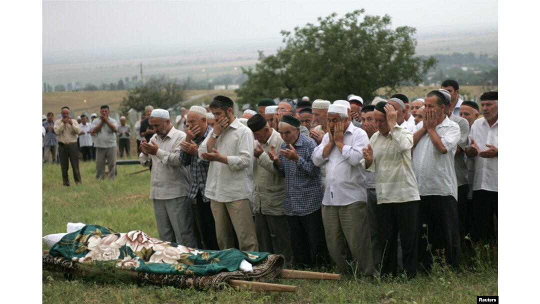 The funeral of Natalya Estemirova at a cemetery in Koshkeldy, 70 kilometers east of Grozny, on July 16, 2009.