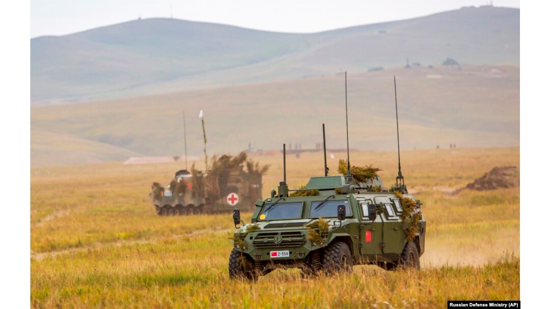 Chinese military vehicles move through a field during military exercises in Russia in September 2018.