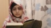 Malala Yousafzai reads a book at the Queen Elizabeth Hospital in Birmingham, where she received treatment after being shot by Taliban militants in her native Swat Valley in 2012.