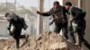 Iraq -- Iraqi special forces soldiers run across a street during a clashes in Mosul. February 28, 2017. 