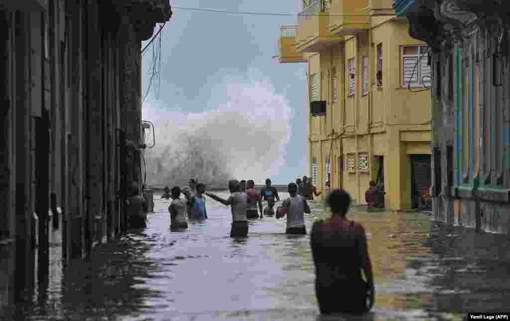 Cubans wade through a flooded street in Havana on September 10 as Hurricane Irma battered the island. (AFP/Yamil Lage)