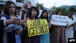 Activists from the Human Rights Commission of Pakistan (HRCP) hold candles and placards during a protest in Islamabad on May 8 against the killing of Pakistani lawyer Rashid Rehman.
