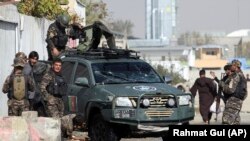 FILE: Afghan security forces inspect the site of suicide bomb attack in Kabul.