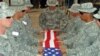 U.S. soldiers fold their national flag during a departure ceremony at Olsen camp in Samarra 