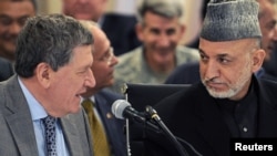 President Hamid Karzai speaks with US Special Representative for Afghanistan and Pakistan Richard Holbrooke in Kabul