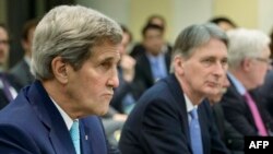 U.S. Secretary of State John Kerry (left) and British Foreign Secretary Philip Hammond wait for a meeting in Lausanne, Switzerland, on March 31.