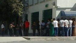 People wait to withdraw cash from ATM machines in Ashgabat.