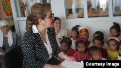 Kyrgyzstan-- Vice Prime Minister Damira Niyazalieva reads fairy tales to students in the Batken region. June 1, 2015. 