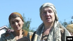 Ingush women hold photos of their kidnapped relatives (file photo)