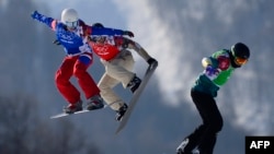 Athletes race in the final in the Snowboard Ladies' Cross at the Extreme Park course.