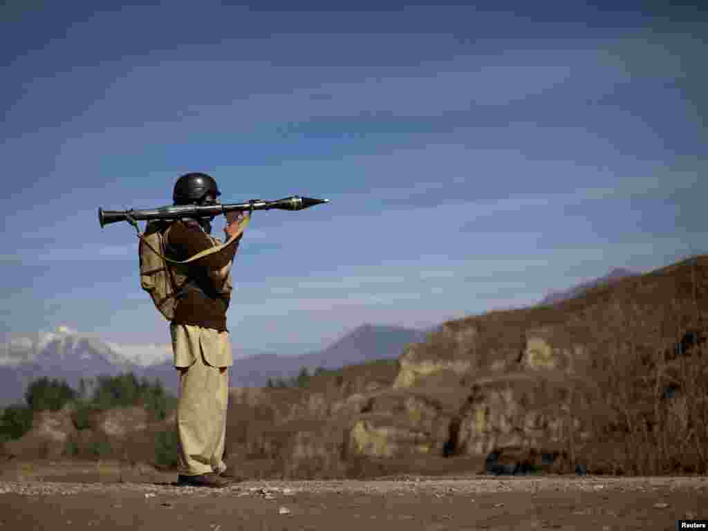 A Pakistani soldier holds a rocket launcher while securing a road in Khar near the border with Afghanistan. - Photo by Adrees Latif for Reuters