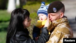 A Ukrainian marine speaks with family members before departing Crimea outside a Ukrainian military base in the Crimean port city of Feodosiya on March 24.
