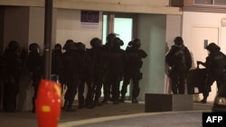 Police conduct a raid in the Croix-Rouge suburb of Reims on January 8 in pursuit of leads and suspects following the deadly attack on the Charlie Hebdo offices in Paris the previous day.