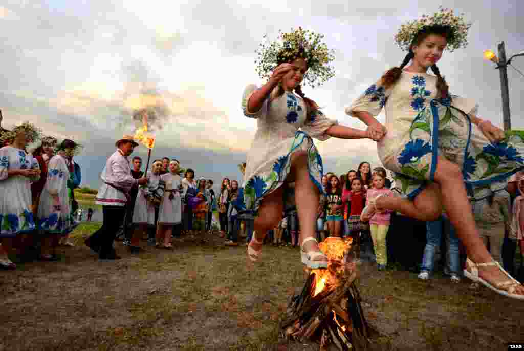 Young people jump over a bonfire as they take part in the Kupala Night celebration, a traditional Slavic holiday, in the Homel region of Belarus. (TASS/Viktor Drachev)