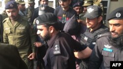 PAKISTAN -- Pakistani police and commandos escort a suspect (C) who is accused of raping and murdering a young girl, as they leave an anti-terrorist court in Lahore, February 7, 2018