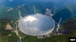 China -- A general view of the five-hundred-meter Aperture Spherical radio Telescope (FAST) under construction in the remote Pingtang county, May 7, 2016