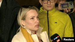 Marina Ovsyannikova told reporters that she endured 14 hours of interrogation in isolation without a lawyer. She said she hopes that “people will open their eyes. Don't be such zombies. Don't listen to this propaganda.”