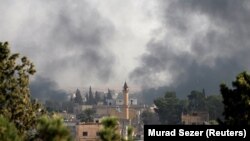 Smoke rises over the Syrian town of Tel Abyad, as seen from the Turkish border town of Akcakale in Sanliurfa province, Turkey, October 10, 2019.