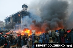 Protesters hold shields as they clash with riot police on February 19.