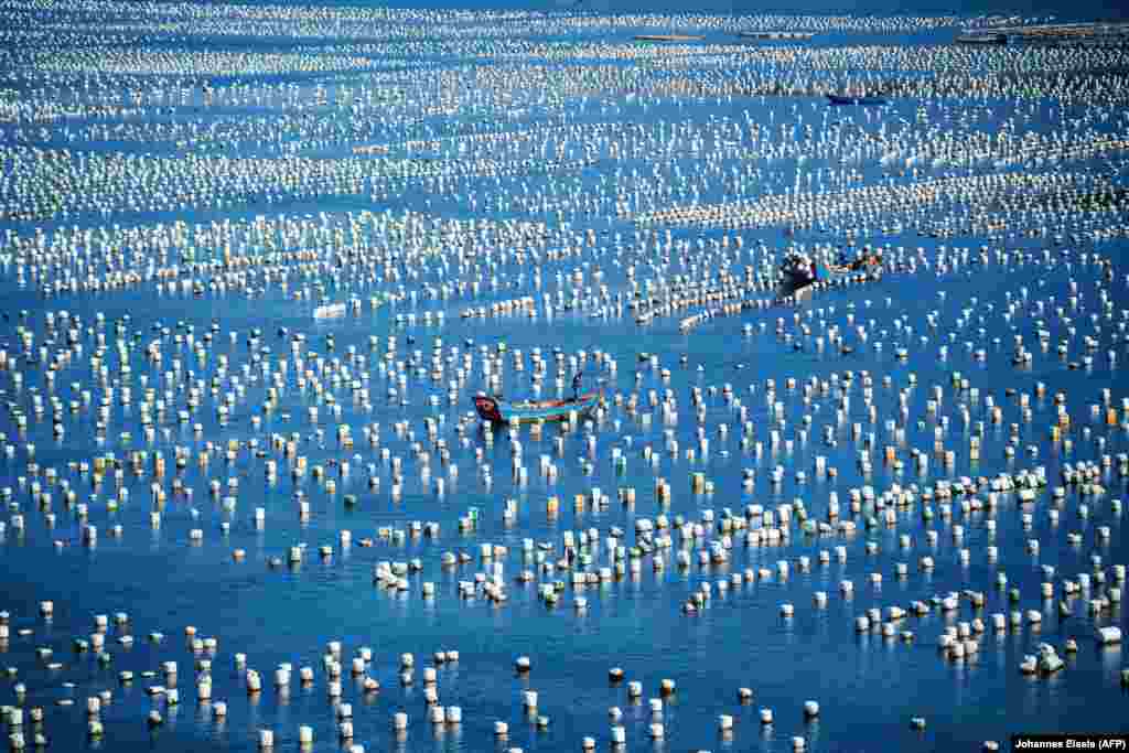 A fisherman passes buoys in the port of Gouqi Island, Zhejiang Province, around 100 kilometers southwest of Shanghai. (AFP/Johannes Eisele)