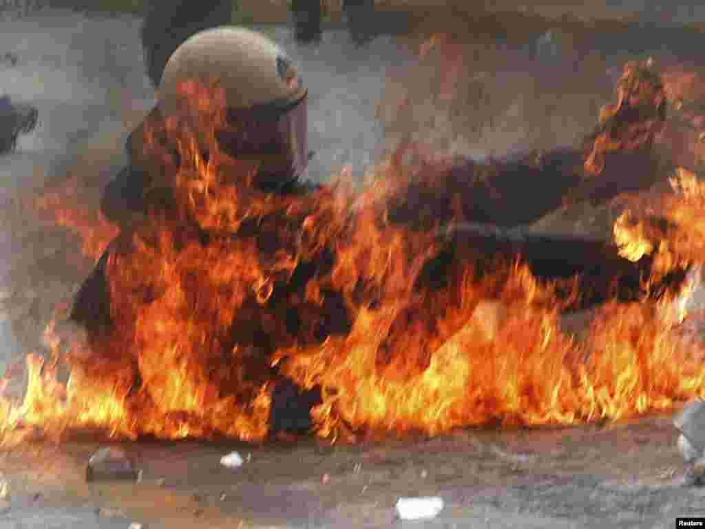 A riot policeman falls after being hit with a Molotov cocktail near the Greek parliament in Athens during a nationwide strike on May 5, called by civil servants protesting against strict austerity measures. Photo by John Kolesidis for Reuters