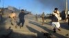 Afghan security officials move injured victims from the scene of a suicide bomb attack that targeted a convoy of foreign forces in Lashkar Gah in November 2015.