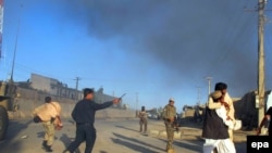 Afghan security officials shift injured victims from the scene of a suicide bomb attack that targeted a conoy of foreign forces in Lashkar Gah, Helmand province in November.