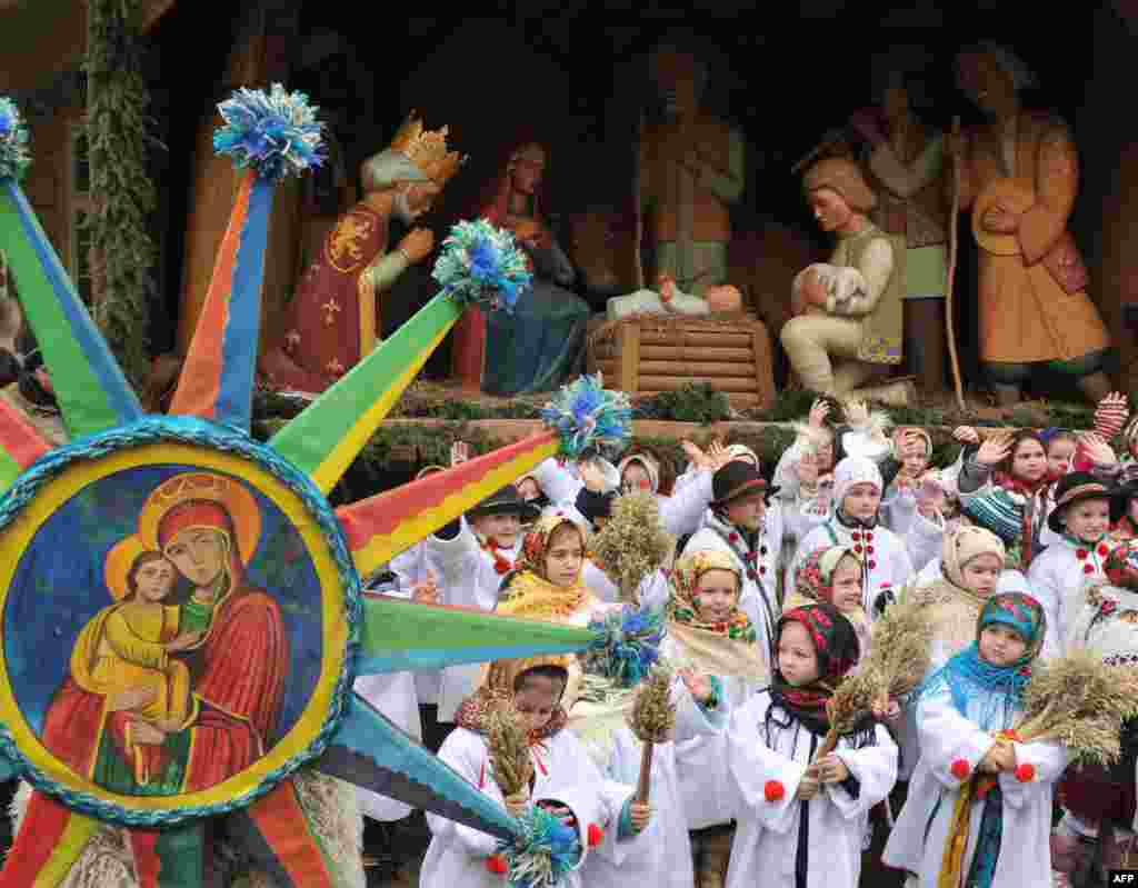 In Ukraine, children wearing traditional clothes take part in an Orthodox Christmas Eve celebration in the western Ukrainian city of Lviv.