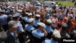 Armenian youth activists demonstrate against bus fare hikes outside municipal offices in Yerevan earlier this week. 