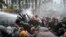 Riot police doused the protesters as they huddled in groups outside the parliament building.&nbsp;